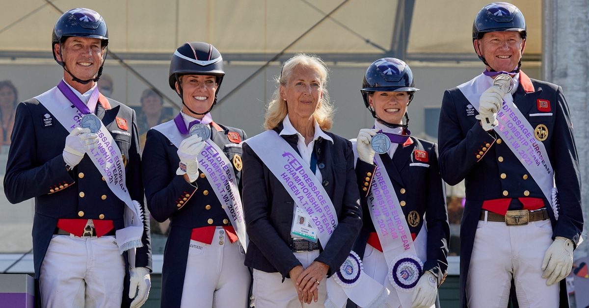 A group of British dressage riders on a podium.